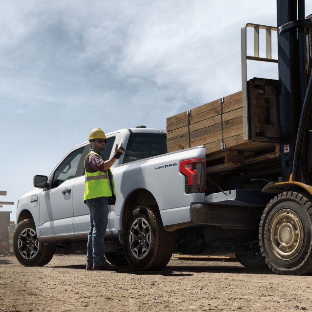 2022 Ford F-150 Lightning Pro loading lumber.