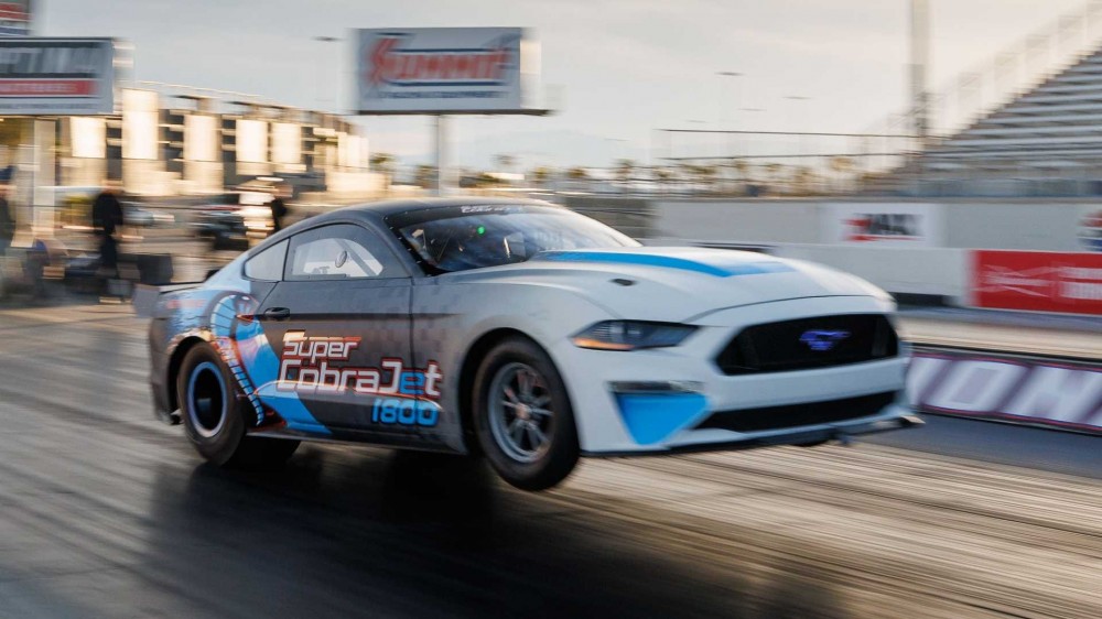 Ford Super Cobra Jet 1800 popping a wheelie on the track.